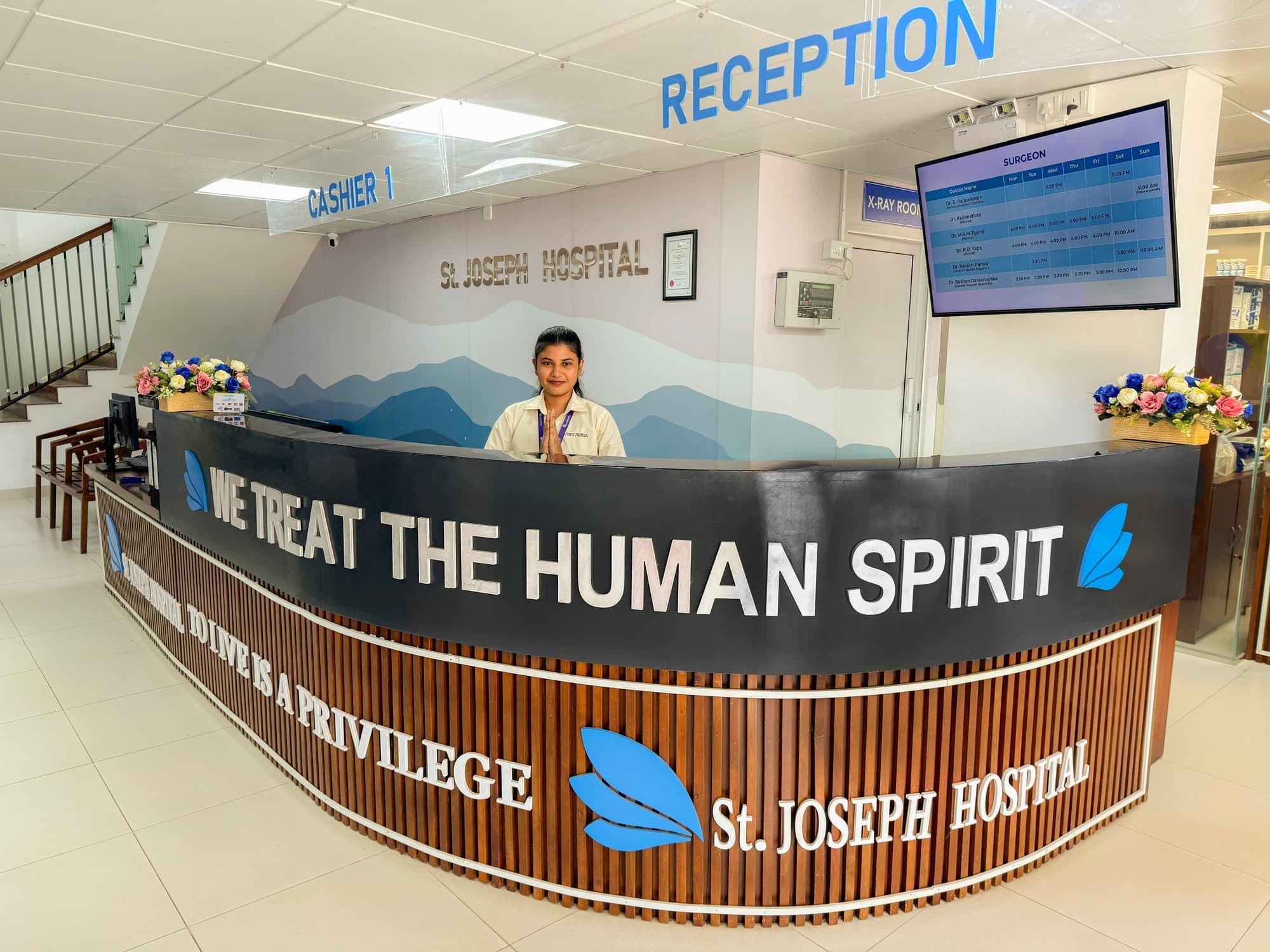 The St. Joseph Hospital reception desk, its counter reading We treat the human spirit.